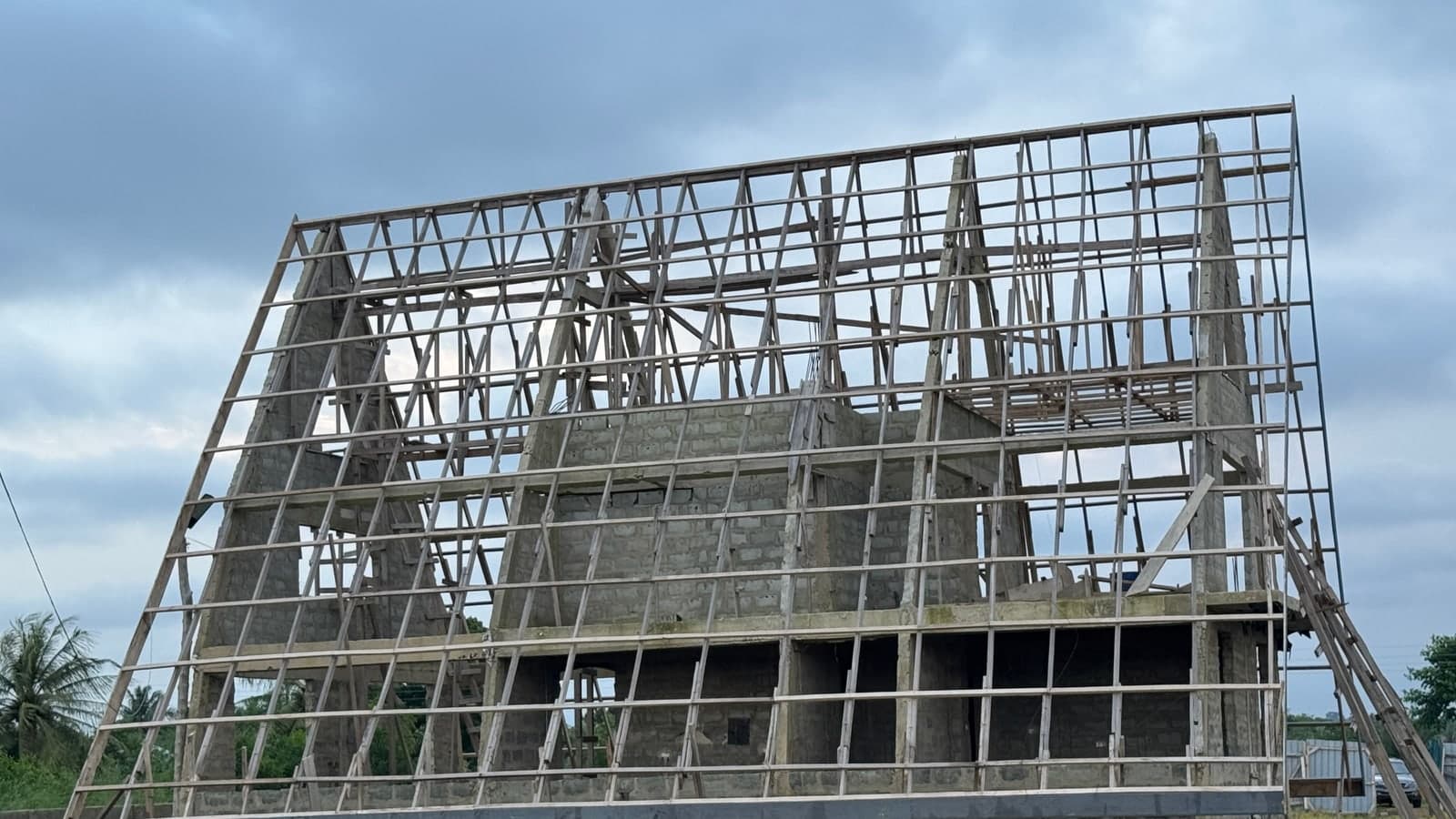 Blockwork and roof structure under construction at a residential site in Akatsi, Volta Region, Ghana, August 2026